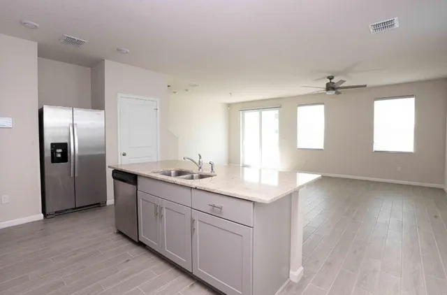 a view of a kitchen island wooden floor and windows