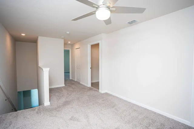 a view of a livingroom with a ceiling fan and window