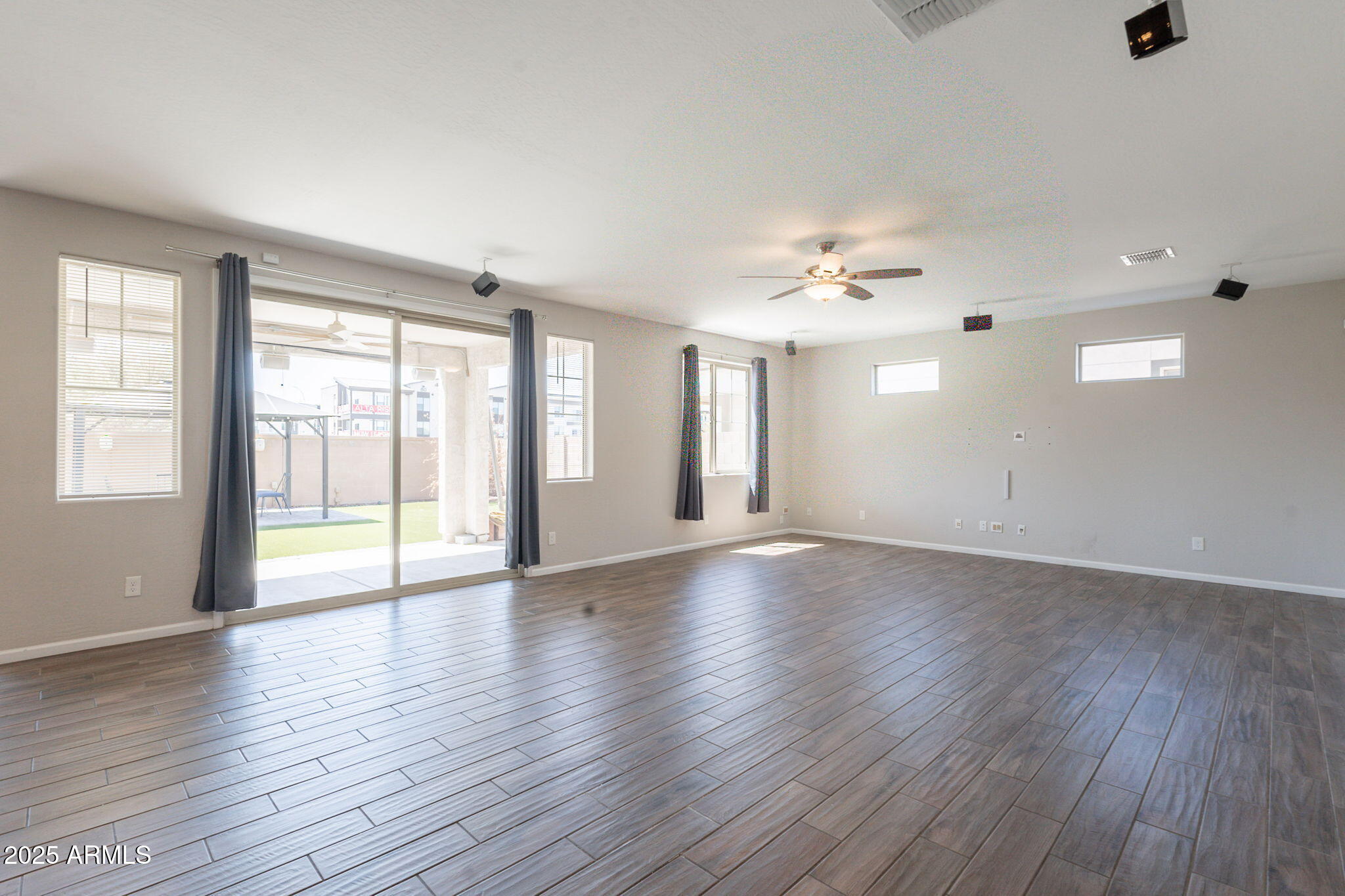 98 North Bay Drive Gilbert, AZ 85233 - Photo 10 of 37 a view of an empty room with a window and wooden floor