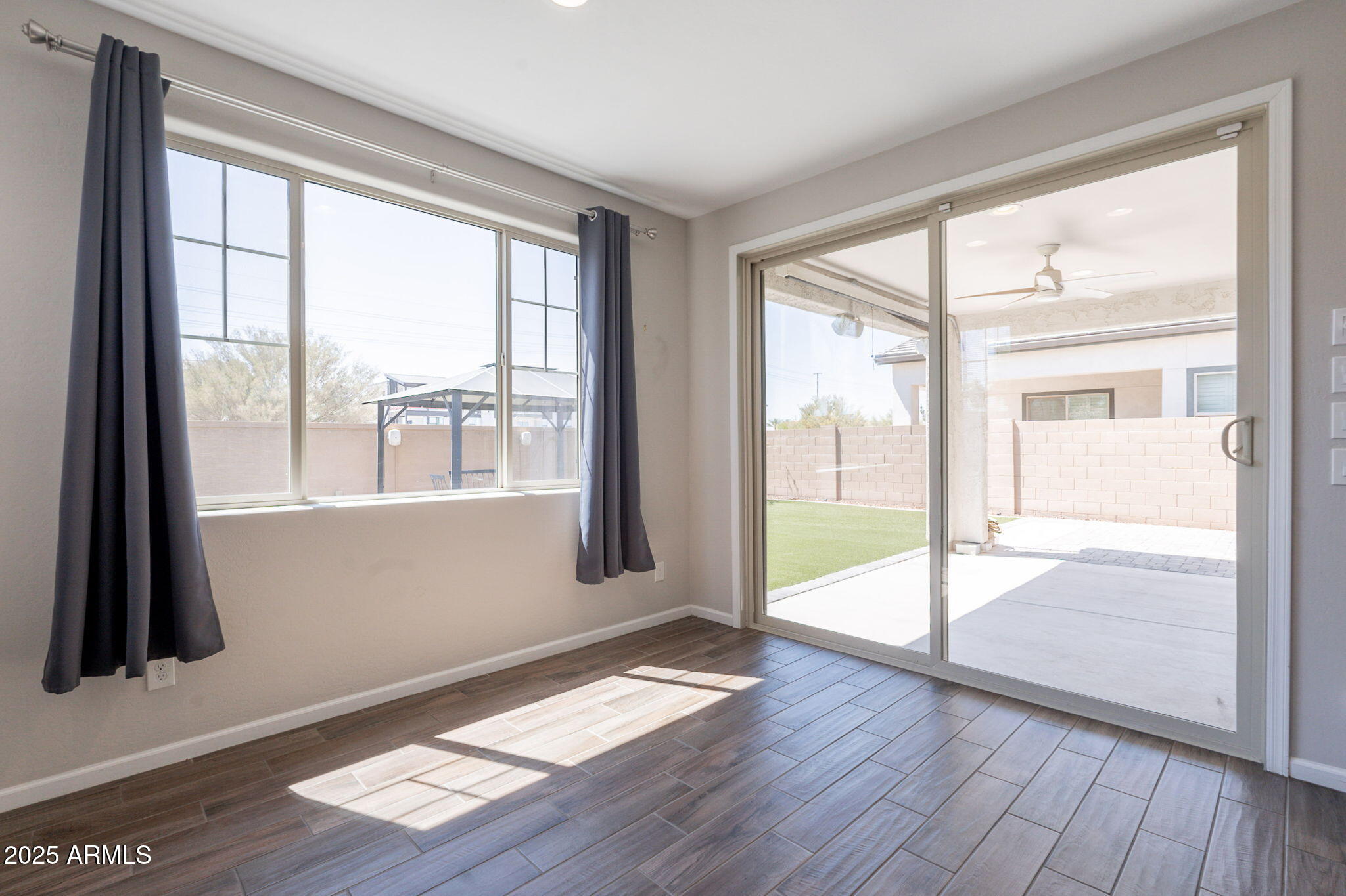 98 North Bay Drive Gilbert, AZ 85233 - Photo 14 of 37 a view of an empty room with wooden floor and a window