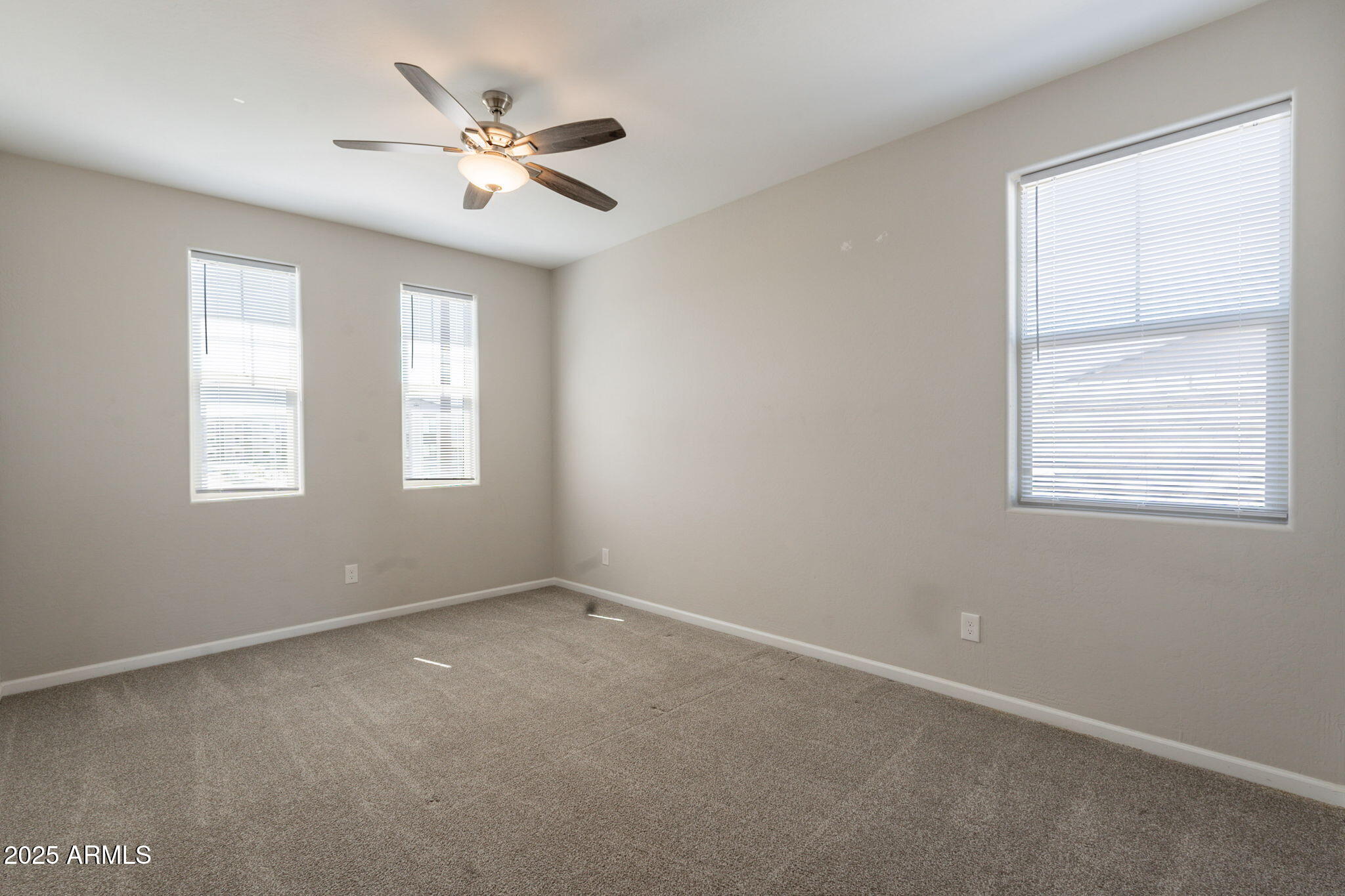 98 North Bay Drive Gilbert, AZ 85233 - Photo 28 of 37 an empty room with windows and ceiling fan