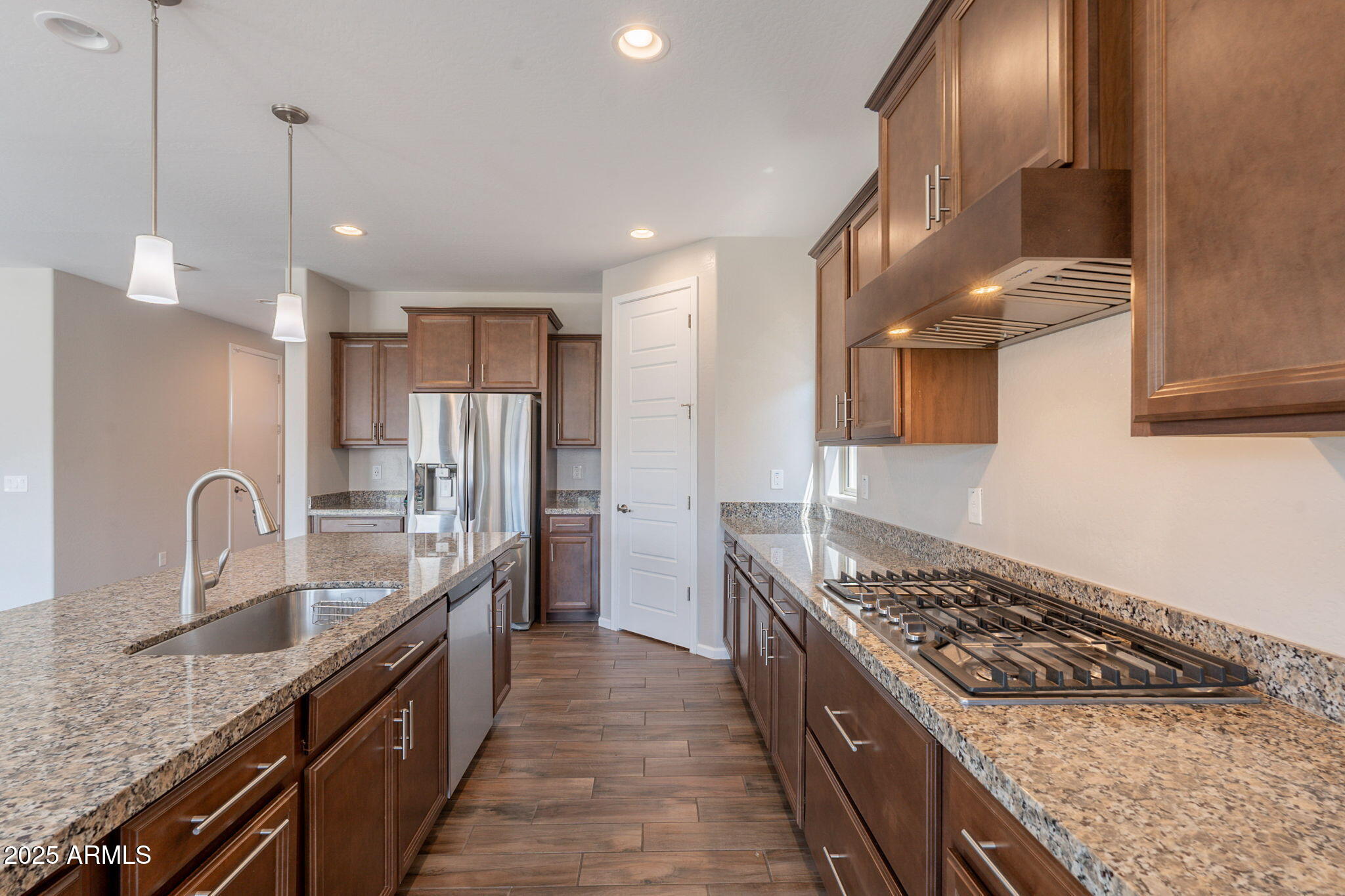 98 North Bay Drive Gilbert, AZ 85233 - Photo 3 of 37 a kitchen with stainless steel appliances granite countertop a sink stove and refrigerator
