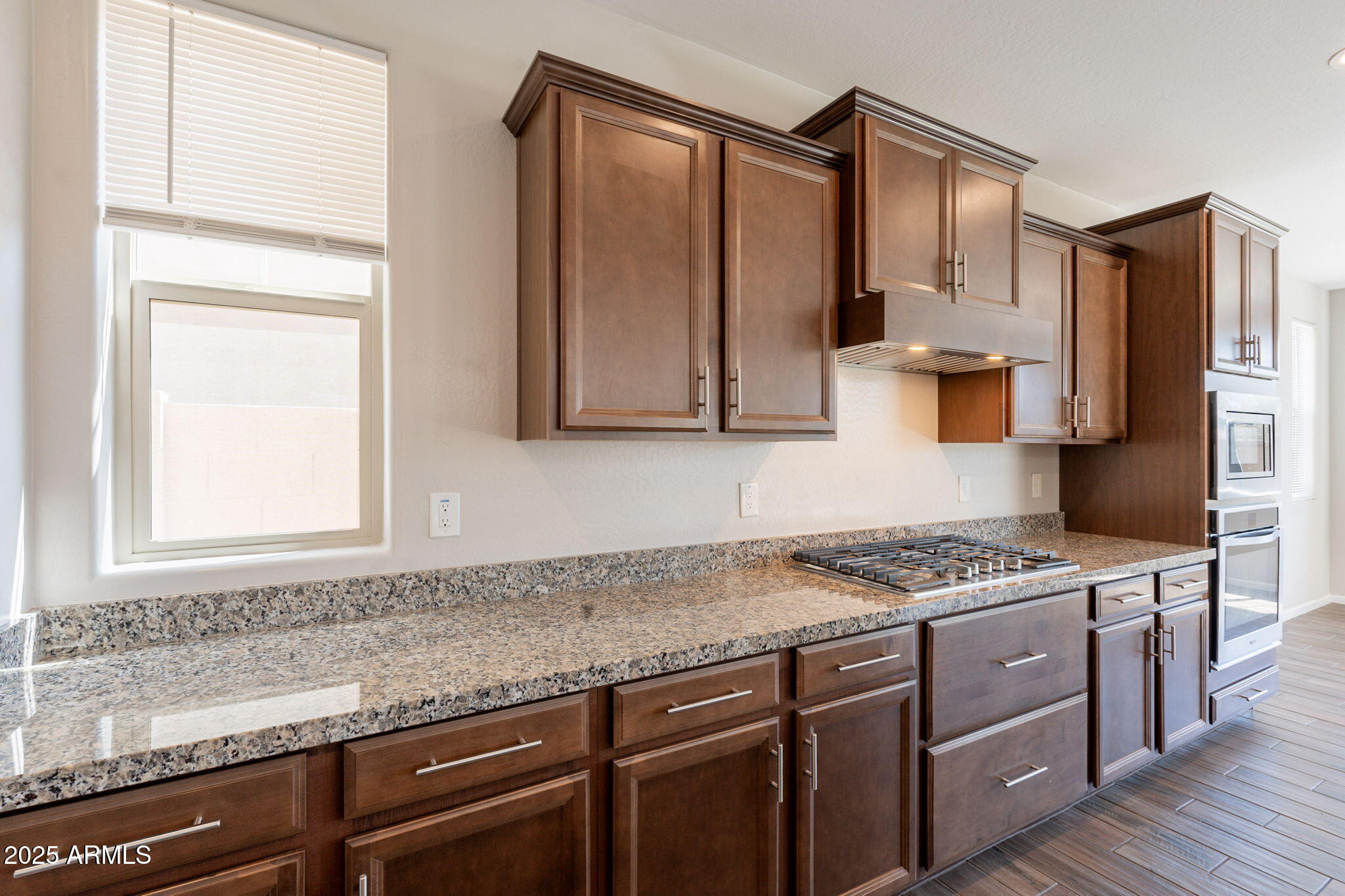 98 North Bay Drive Gilbert, AZ 85233 - Photo 4 of 37 a kitchen with stainless steel appliances granite countertop a sink stove and cabinets