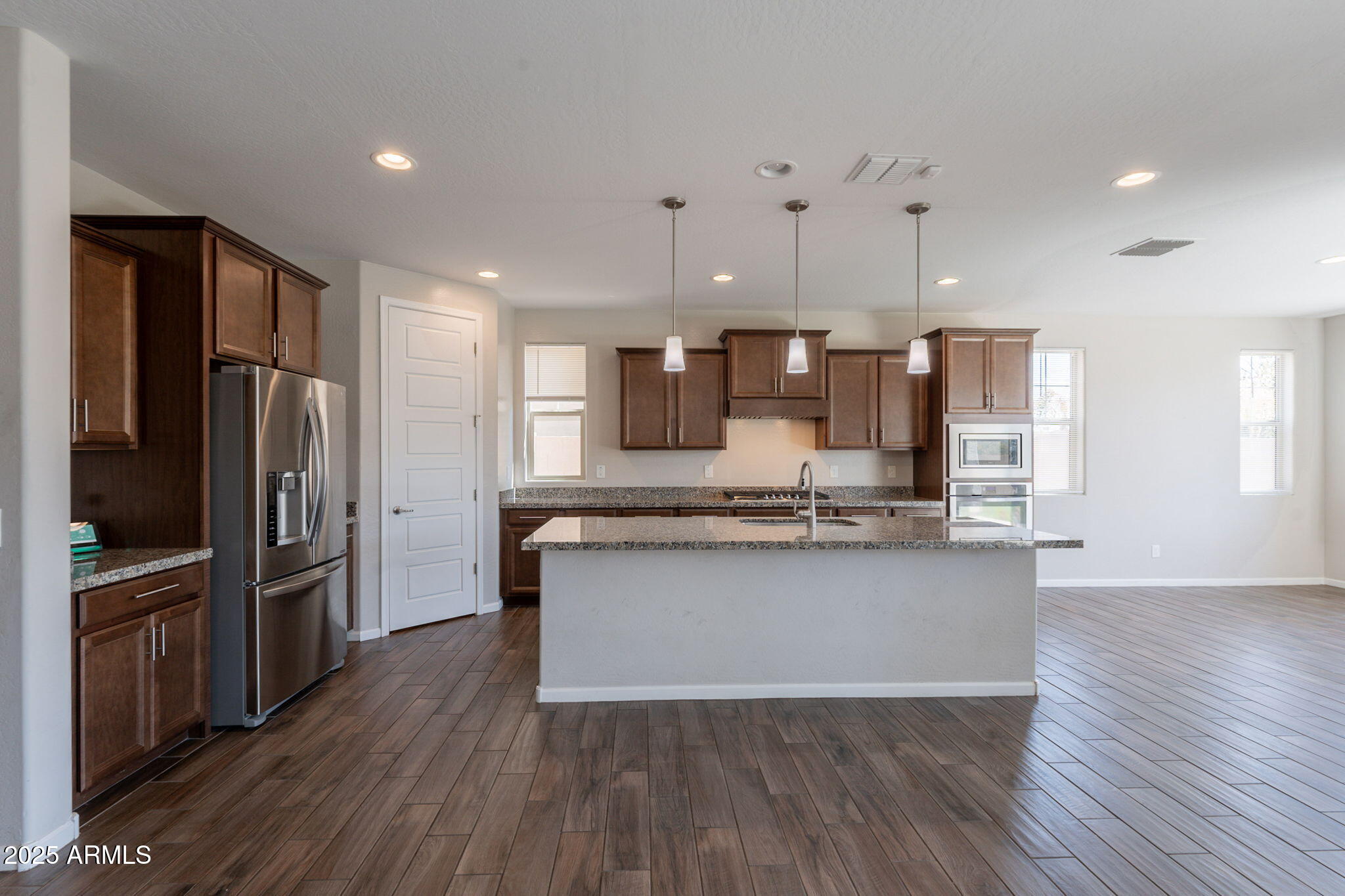98 North Bay Drive Gilbert, AZ 85233 - Photo 7 of 37 a kitchen with stainless steel appliances a refrigerator sink and stove