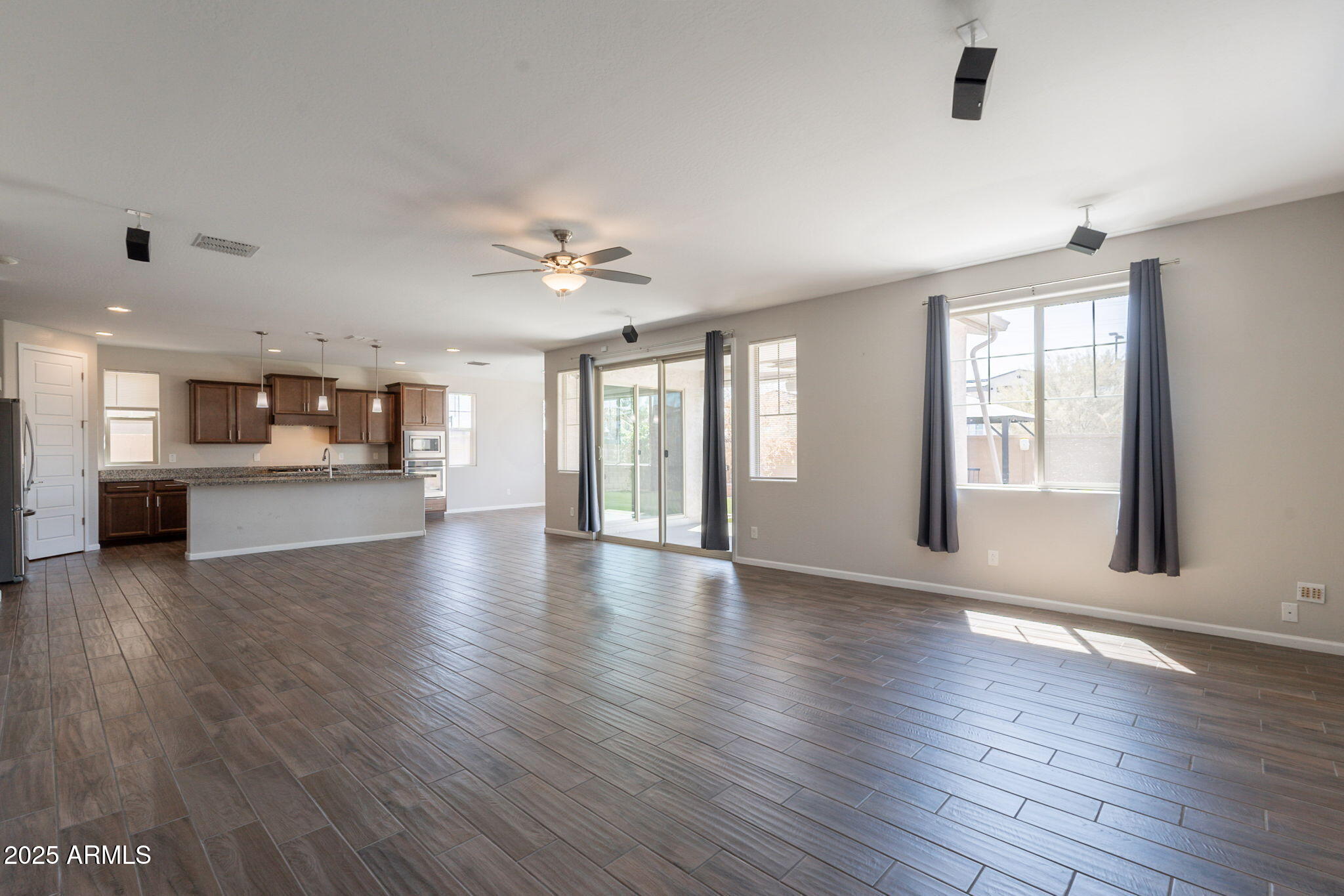 98 North Bay Drive Gilbert, AZ 85233 - Photo 9 of 37 a view of an empty room with wooden floor and a kitchen