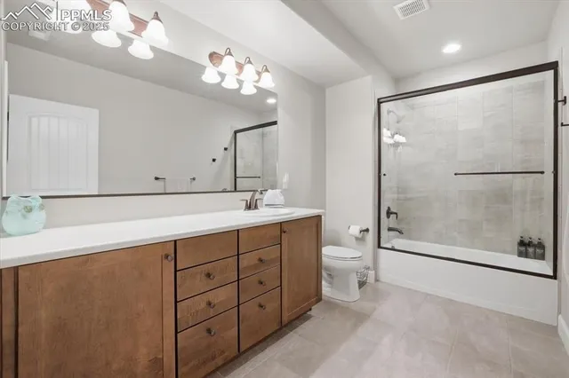 a spacious bathroom with a double vanity sink mirror and toilet