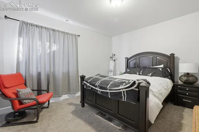 a bedroom with a bed and chair