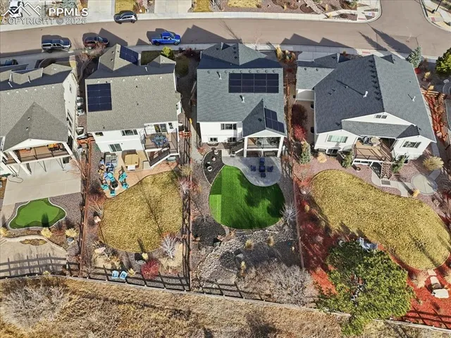 an aerial view of a house with a yard and lake view