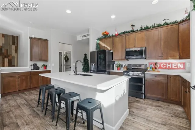 a kitchen with stainless steel appliances a sink stove and refrigerator