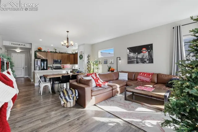 a living room with lots of furniture and kitchen view