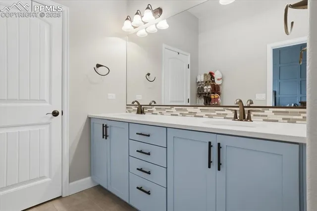 a bathroom with a double vanity sink and a mirror