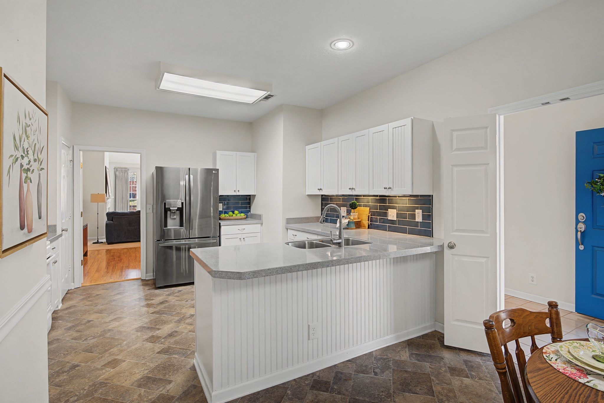 231 Green Harbor Road, Unit 8 Old Hickory, TN 37138 - Photo 11 of 36 a kitchen with stainless steel appliances granite countertop a refrigerator a stove a sink dishwasher and white cabinets with wooden floor