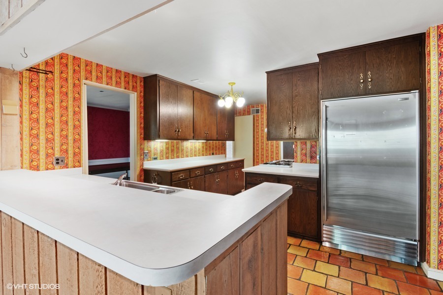 285 Old Farm Road Northfield, IL 60093 - Photo 11 of 21 a kitchen with stainless steel appliances kitchen island granite countertop a refrigerator and a sink