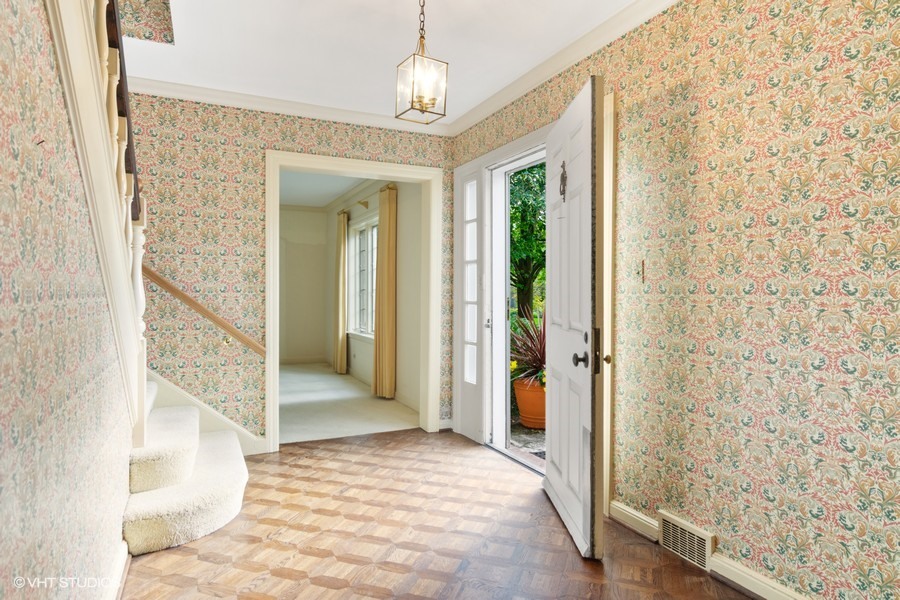 285 Old Farm Road Northfield, IL 60093 - Photo 3 of 21 a view of a hallway view with wooden floor and staircase