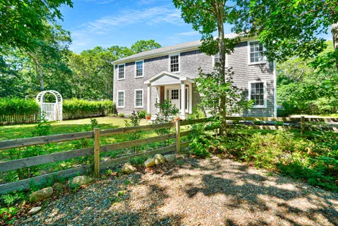 a front view of a house with a garden