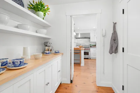a kitchen with stainless steel appliances kitchen island granite countertop a refrigerator and a sink