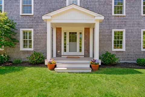 a front view of a house with a yard