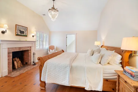 a bedroom with a bed and a fireplace