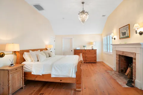 a bedroom with a bed and a fireplace