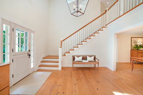 a view of entryway and hall with wooden floor