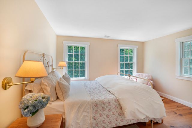 a bedroom with a bed and a window with outer view