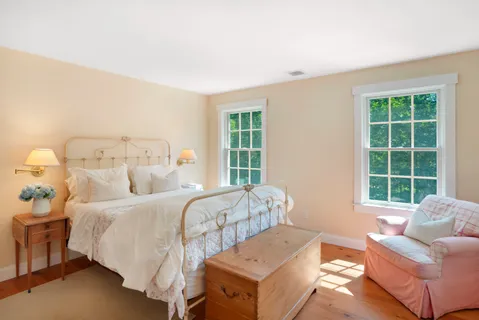 a bedroom with a bed and a couch with window