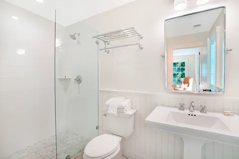 a bathroom with a sink toilet and shower