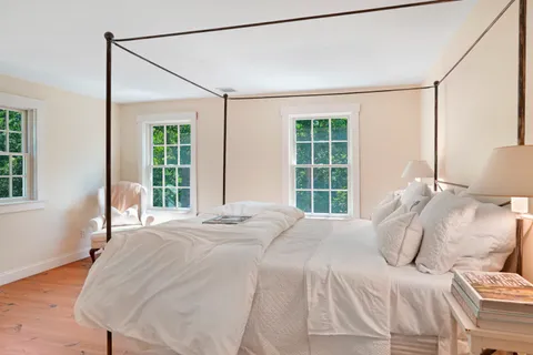 a bedroom with a large bed and a large window
