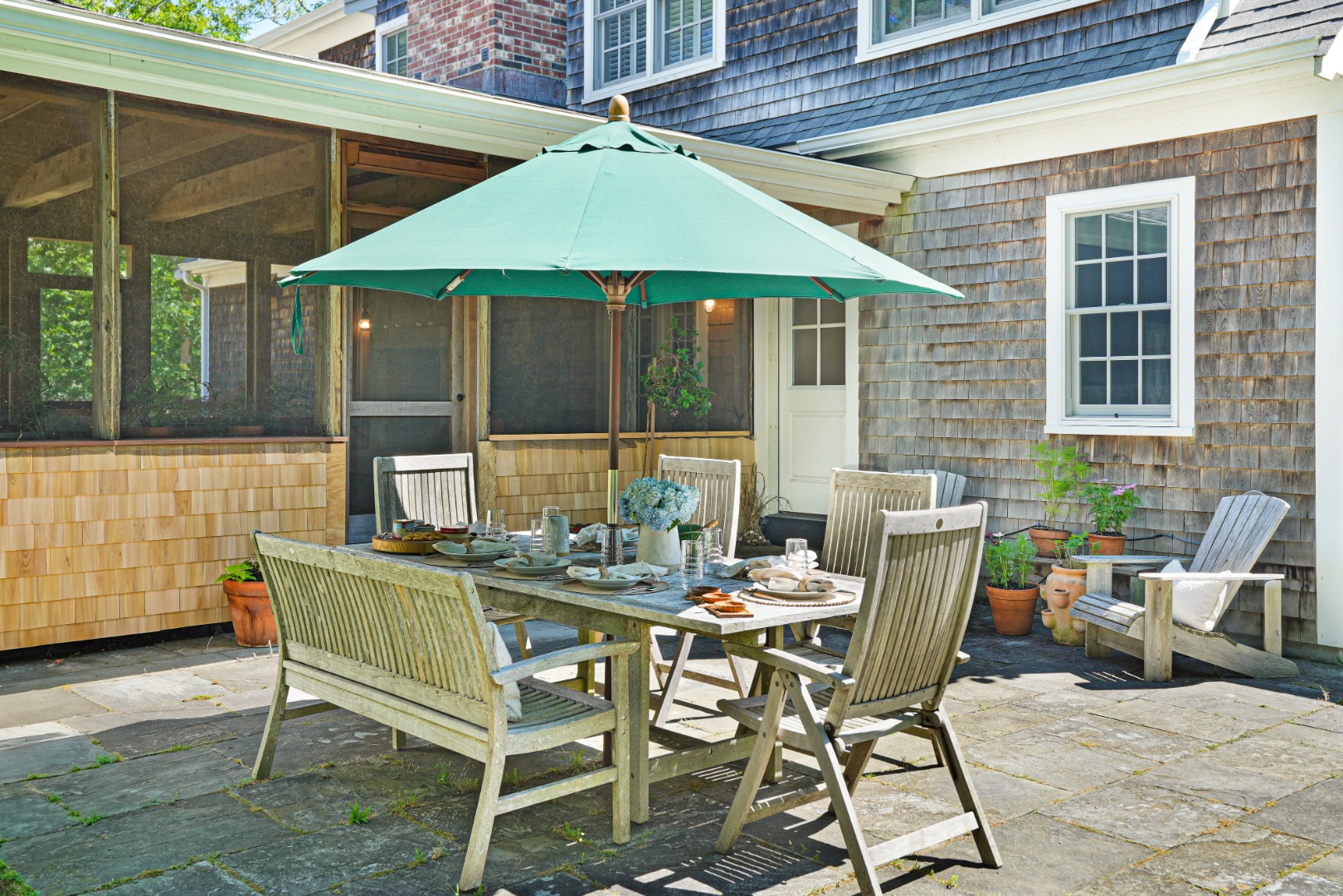 53 Stoney Hill Road West Tisbury, MA 02568 - Photo 43 of 51 a view of a patio with table and chairs under an umbrella