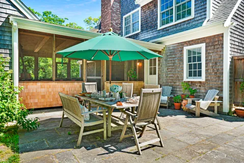 a view of house with deck and wooden floor