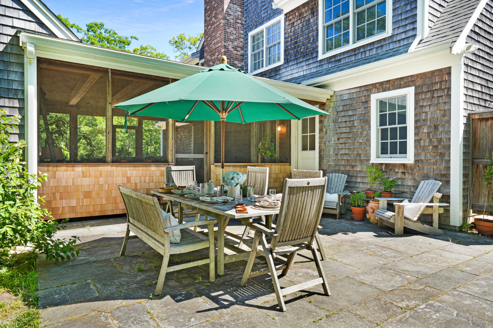 53 Stoney Hill Road West Tisbury, MA 02568 - Photo 44 of 51 a view of patio with chairs and table under an umbrella