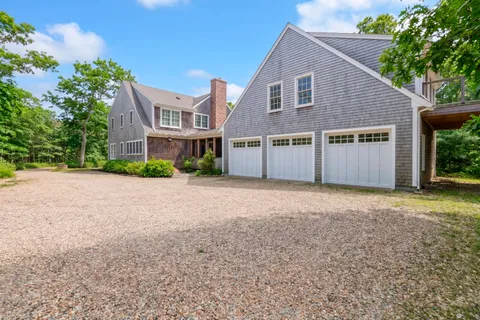 an aerial view of a house with a yard and swimming pool