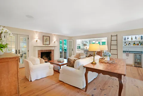 a living room with furniture a fireplace and a table