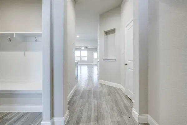 a view of hallway with wooden floor
