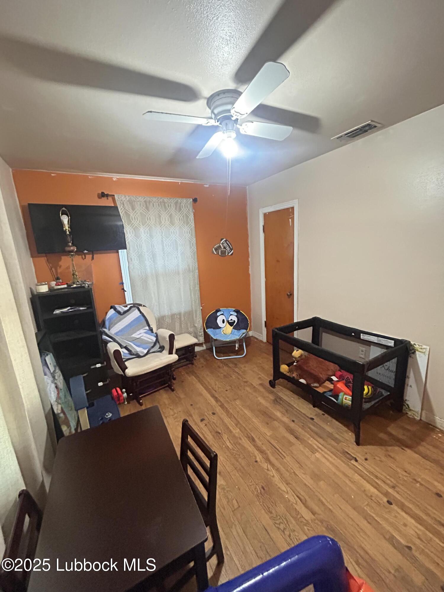 2712 37th Street Lubbock, TX 79413 - Photo 11 of 12 a living room with furniture and wooden floor