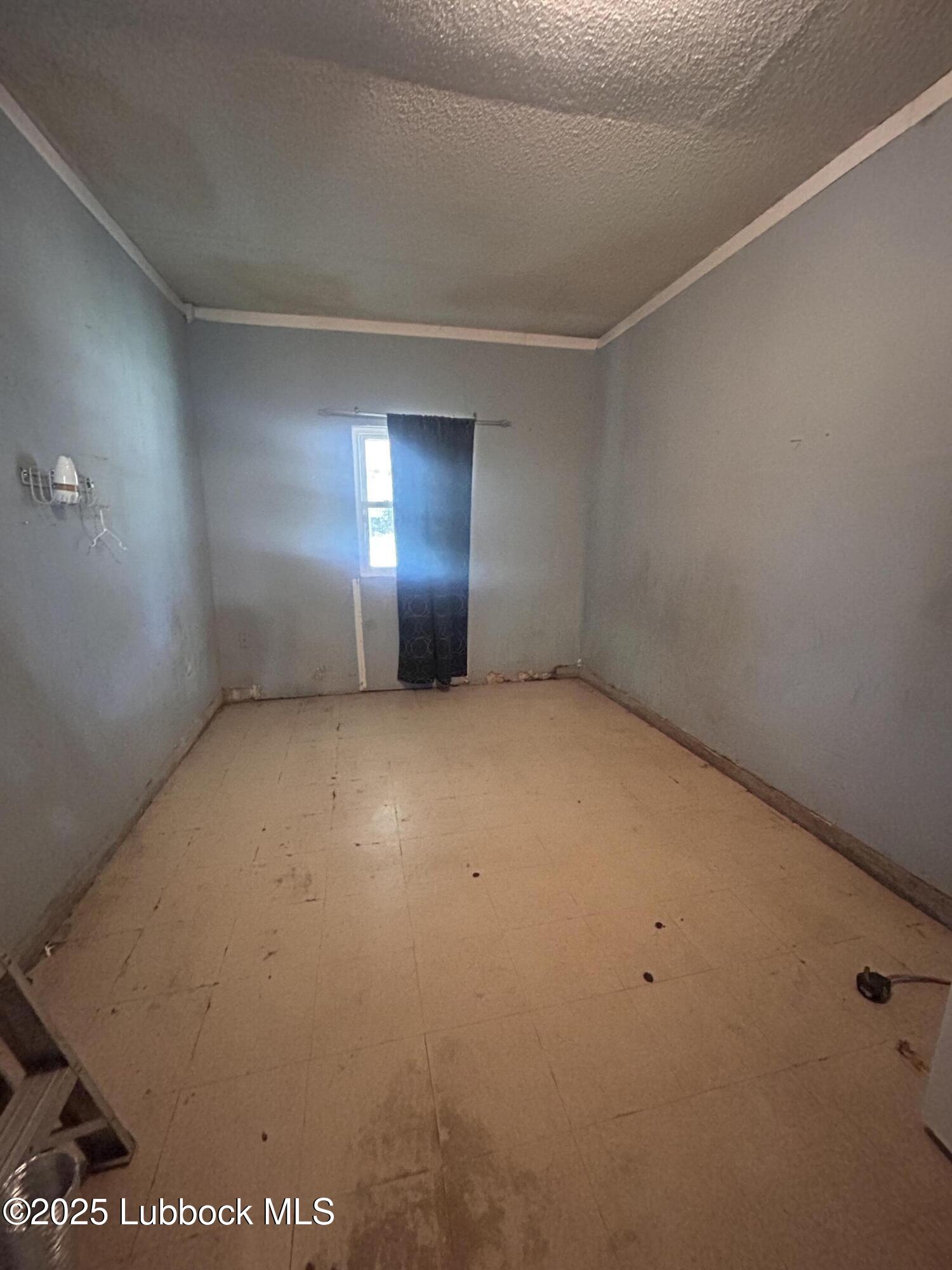 2712 37th Street Lubbock, TX 79413 - Photo 12 of 12 an empty room with windows