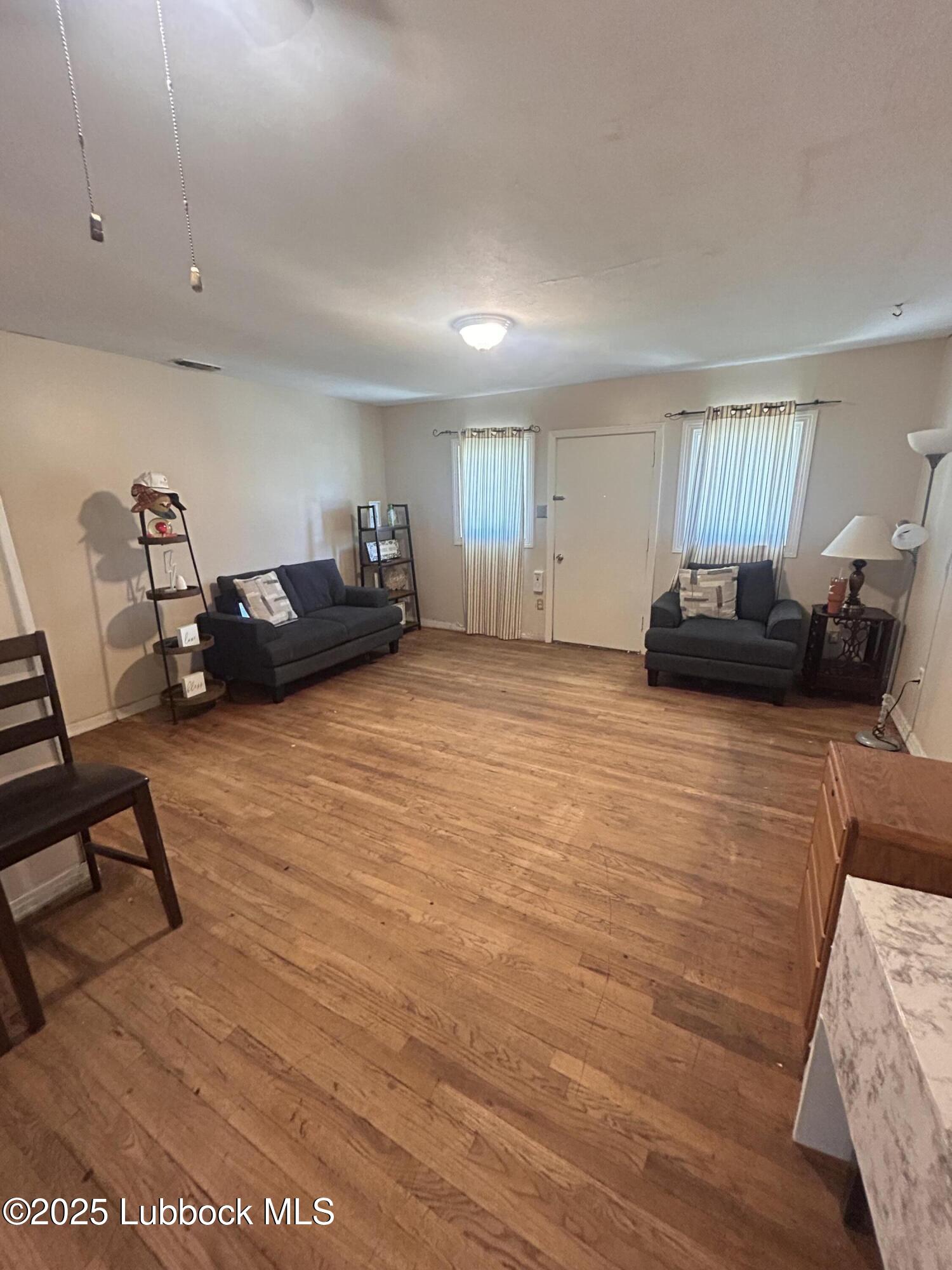 2712 37th Street Lubbock, TX 79413 - Photo 2 of 12 a view of a livingroom with furniture and a couch