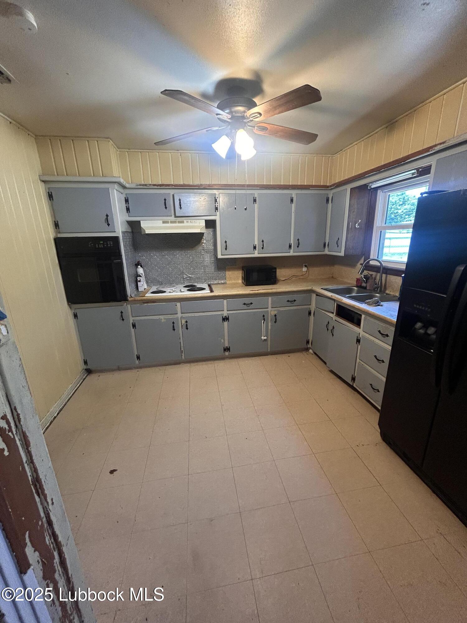 2712 37th Street Lubbock, TX 79413 - Photo 6 of 12 a kitchen with stainless steel appliances granite countertop a sink and cabinets