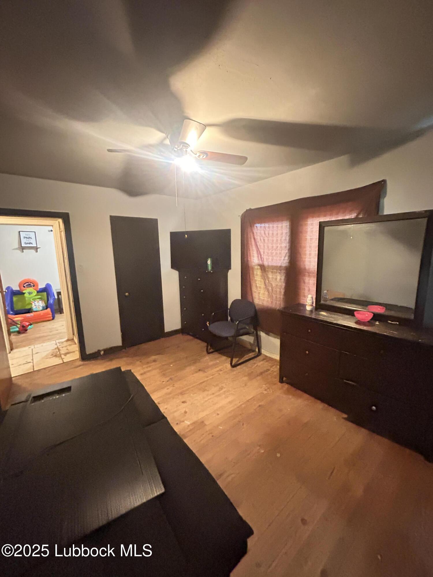 2712 37th Street Lubbock, TX 79413 - Photo 8 of 12 a living room with furniture and a flat screen tv