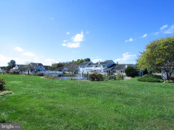 a view of a big yard with a house in the background