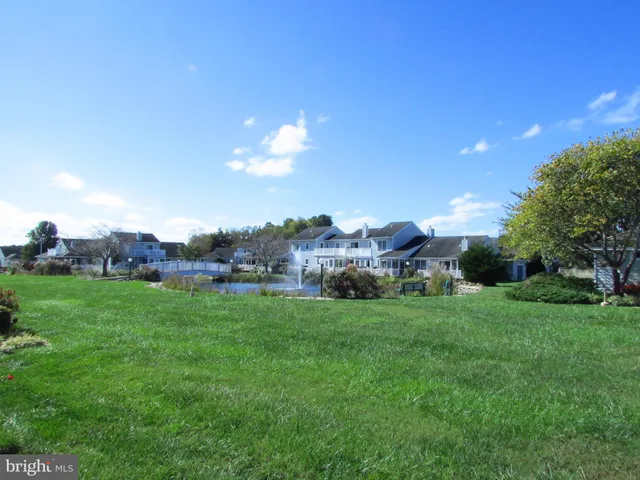 a view of a big yard with a house in the background