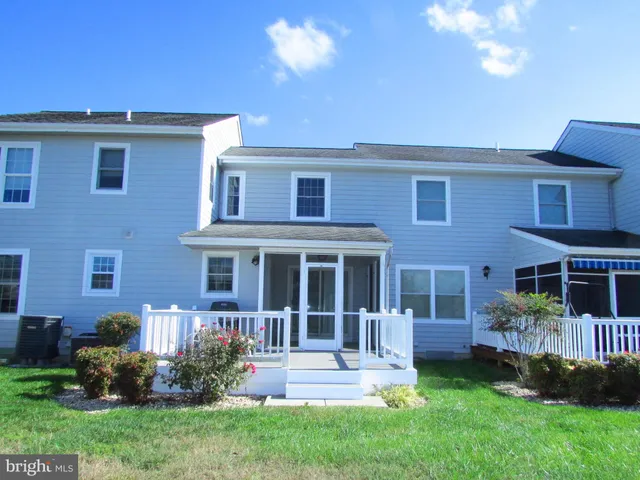a view of a house with a yard and plants