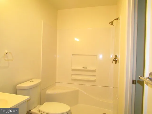 a bathroom with a toilet sink and shower