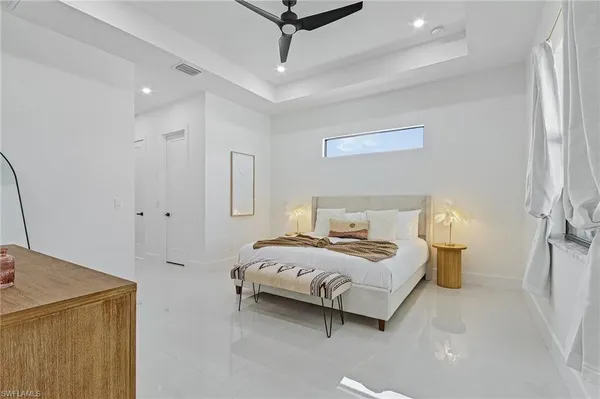 a bedroom with a bed and a chandelier