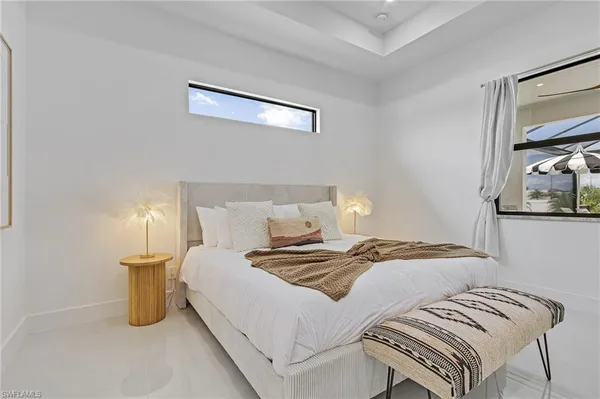 a bedroom with a bed and a lamp