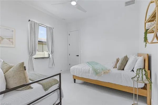 a bedroom with bed and window