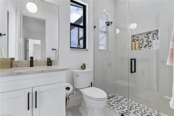 a bathroom with a sink toilet and shower