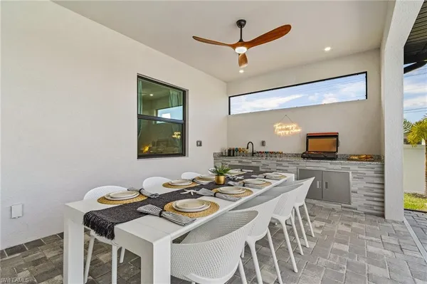 a kitchen with a stove a table and chairs in it