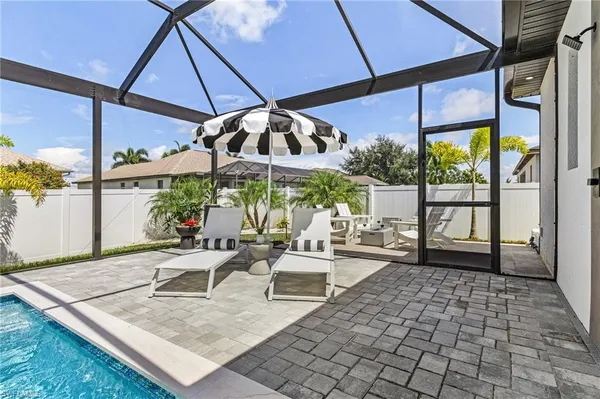 a view of a chairs and table in patio