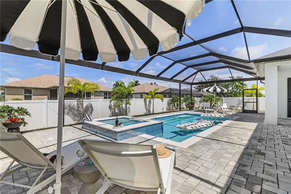 a view of backyard of a house with seating space